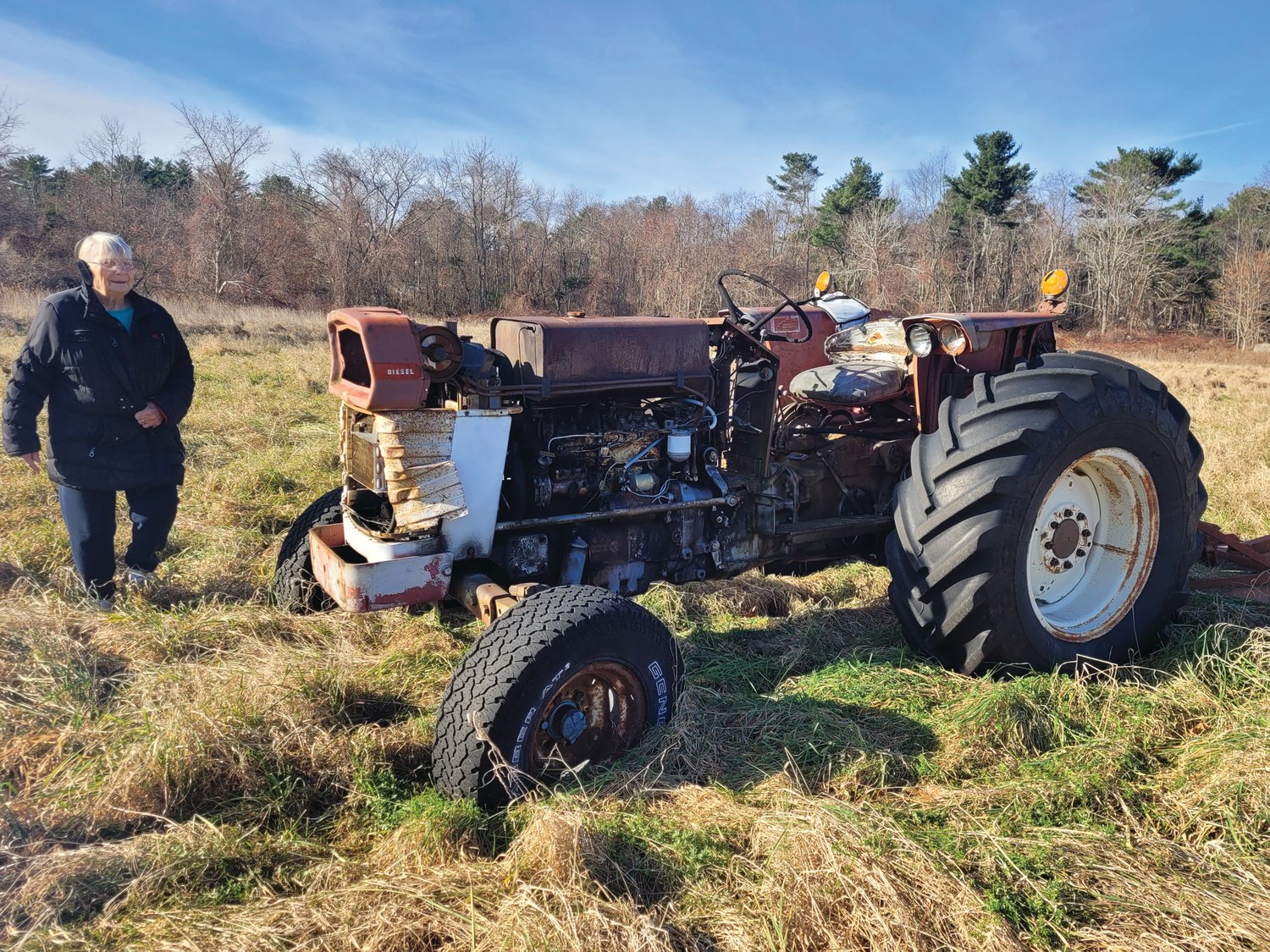 STILL KICKING: Sally Hicks, of Scituate, approaches her old old Massey Ferguson tractor. Neither Sally nor the tractor is ready to quit yet.